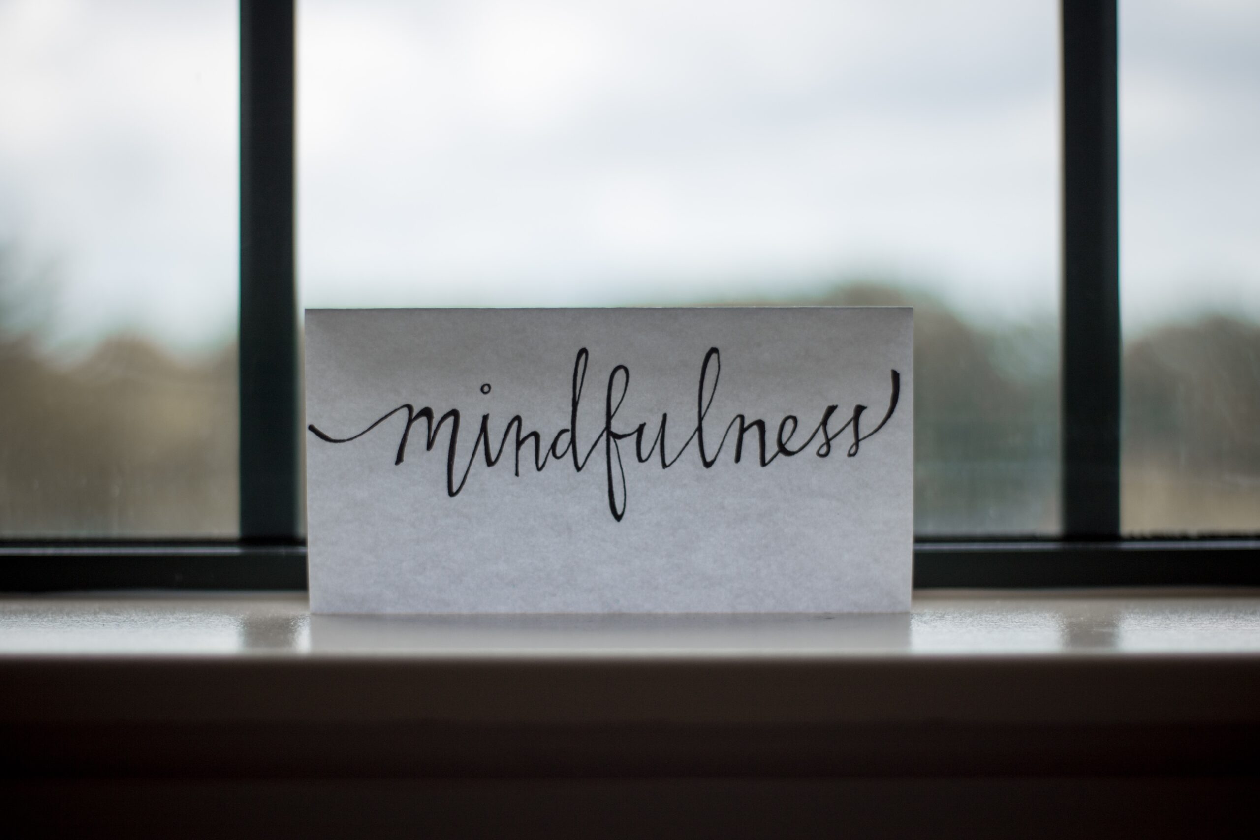 Mindfulness printed on paper near office window