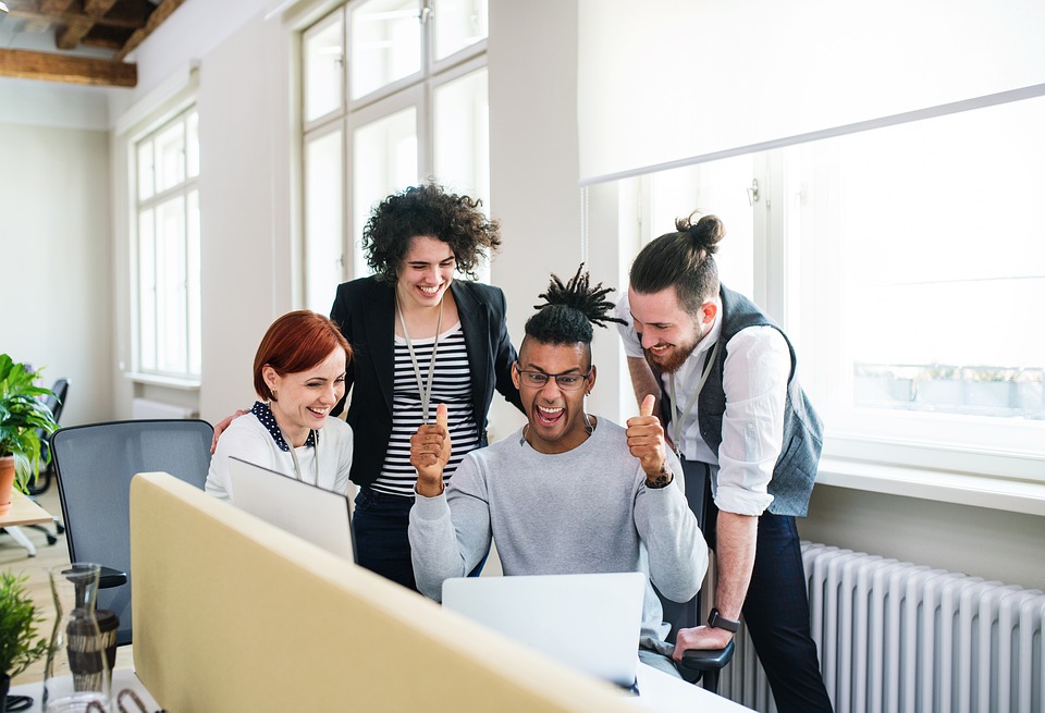 Four colleagues working together happily