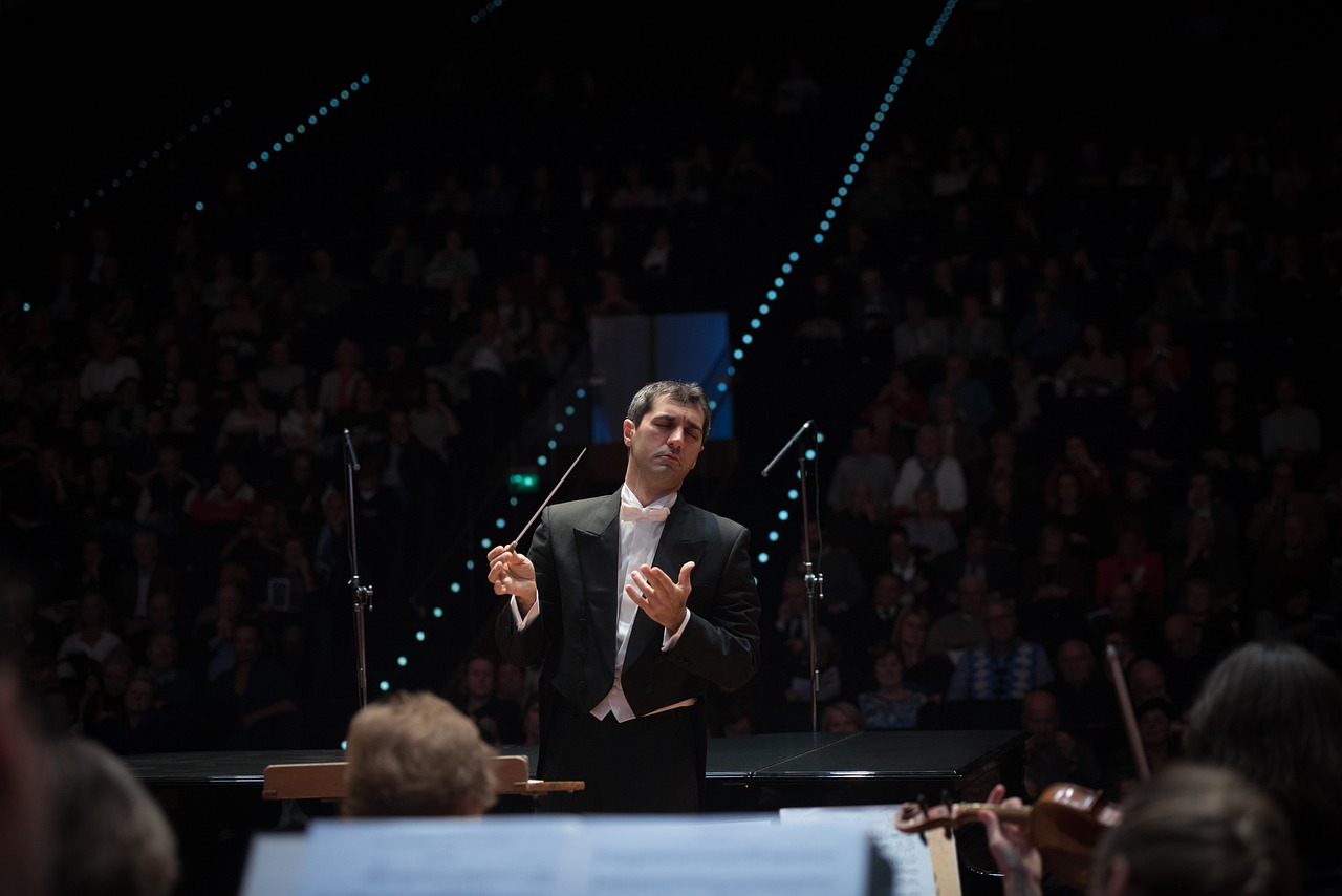 An orchestra conductor in the middle of performance