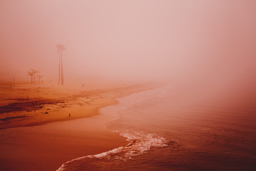 Dark orange horizon over a beach