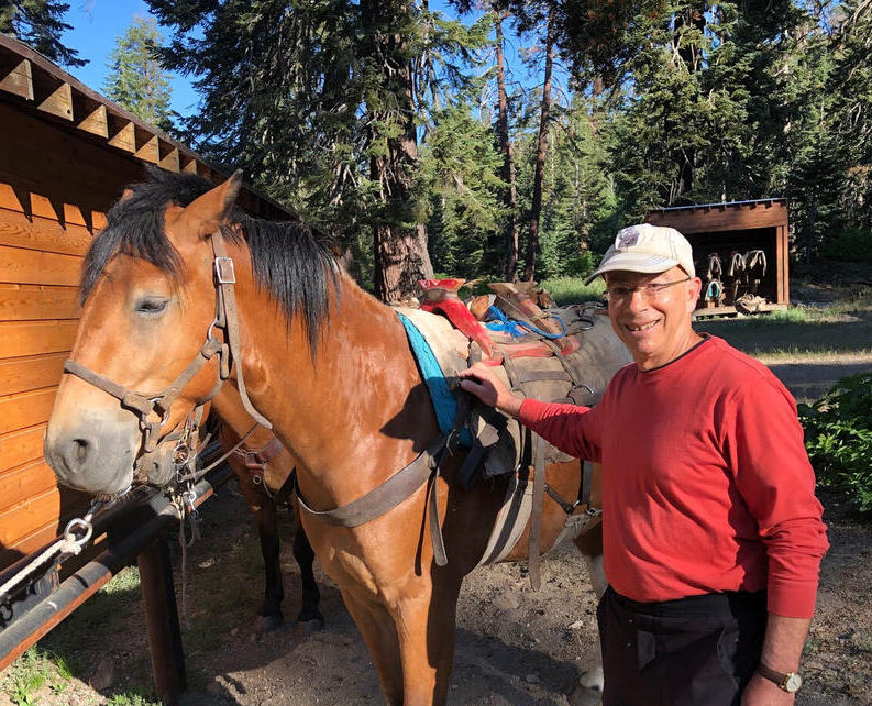 Marc Lesser and a horse in the mountain