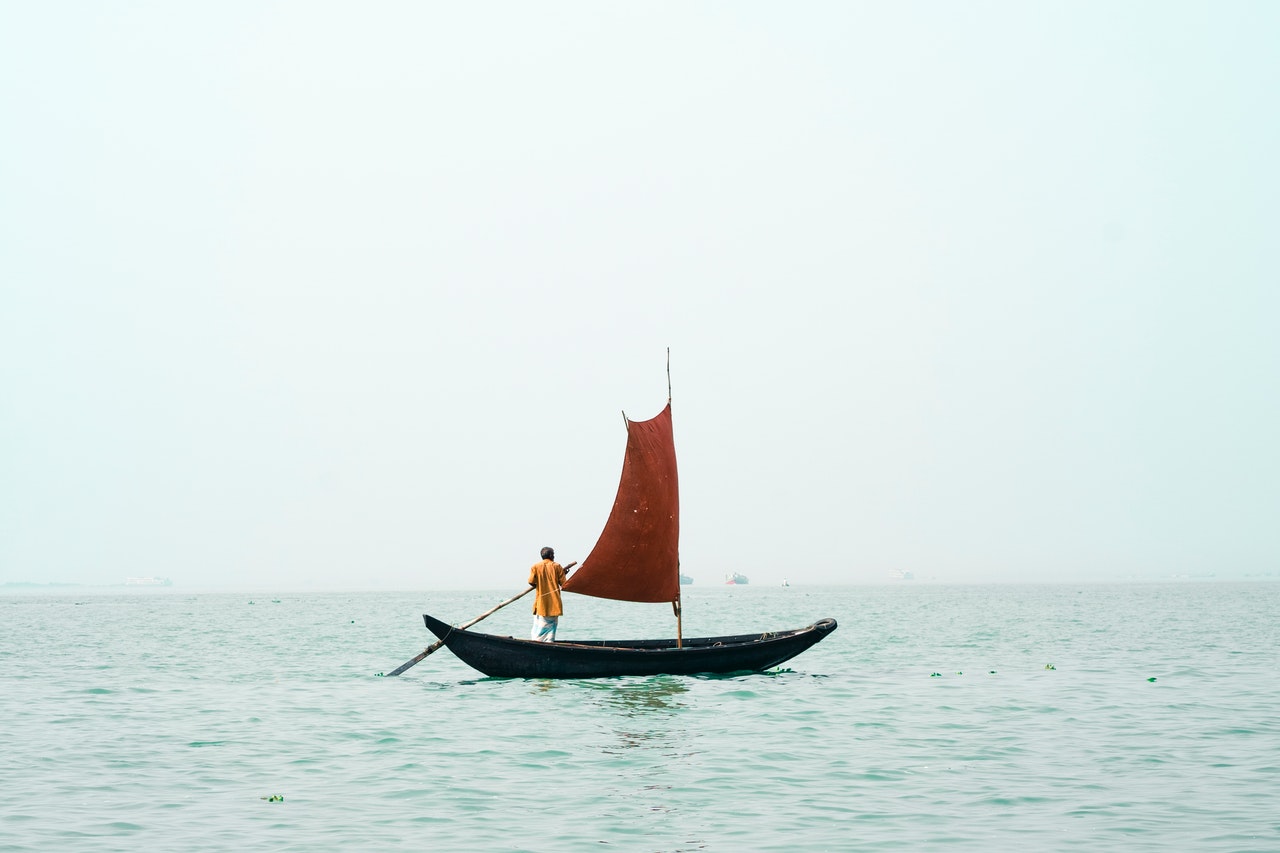 A man calmly sailing in a small boat